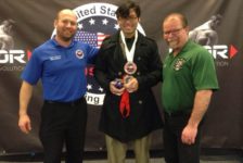 Community member powerlifts in dress clothes to overcome personal struggle, honor his identity