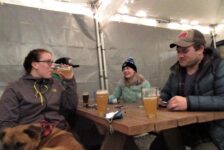 Four people sit at an outdoor patio at Fishers Brewing Company