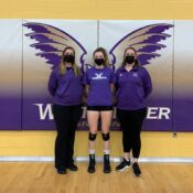 Audrey Green stands with her coaches after a volleyball game.