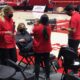 Malia Shoji works while holding her baby at the Huntsman Center.