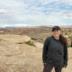 Shellby Carvalho, a female student, stands outside, poses on top of a rock structure in Canyonlands, Utah.