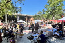 Richer Commons is filled with students walking round multiple tables.