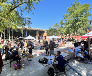 Richer Commons is filled with students walking round multiple tables.