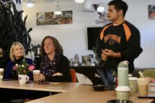 Three people in the SEB Suite in Shaw at the Doughnuts and Discussions event hosted by ASW.