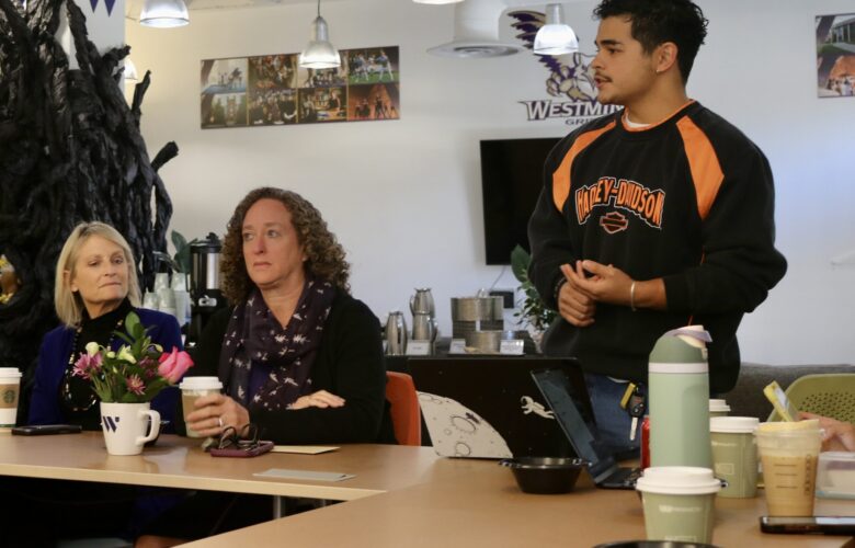 Three people in the SEB Suite in Shaw at the Doughnuts and Discussions event hosted by ASW.